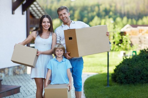 Movers handling boxes carefully in a Canary Wharf property